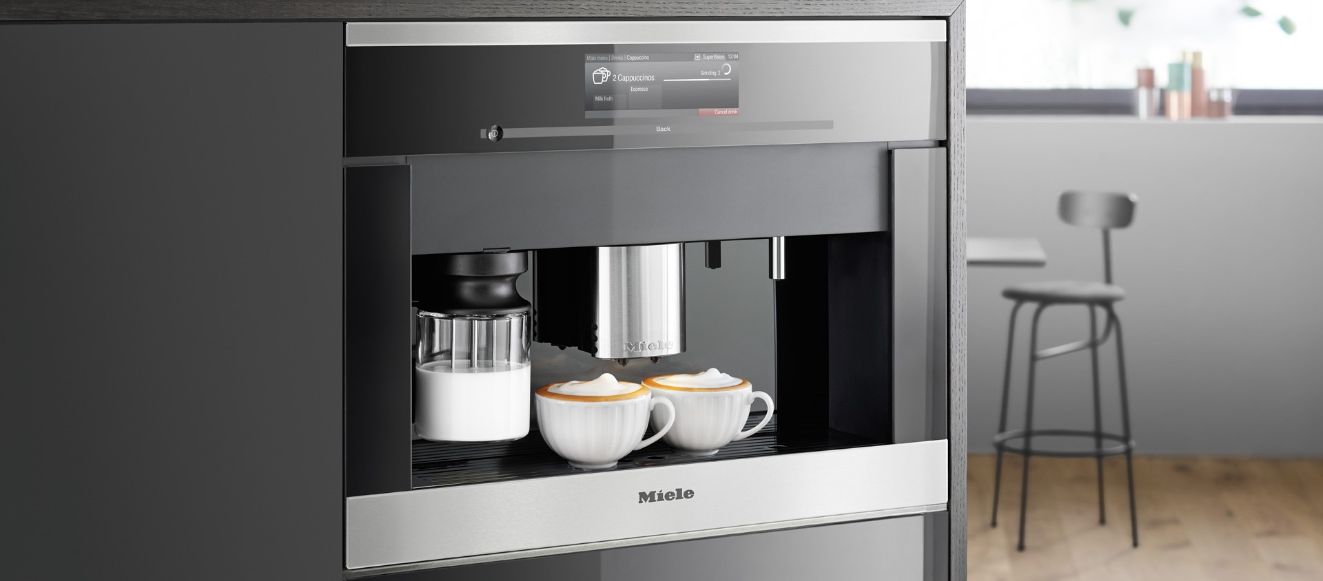 Miele built-in coffee machine preparing cappuccino
